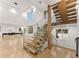 Modern light oak floating staircase with glass railings in a bright two story home at 2635 Camp Branch Rd, Buford, GA 30519