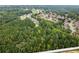 Aerial view of a large wooded area next to a highway with a new home community visible in the background at 2635 Camp Branch Rd, Buford, GA 30519