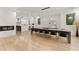 Open concept dining room with long wood table, black velvet chairs, and marble fireplace at 2635 Camp Branch Rd, Buford, GA 30519