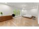 Bright main bedroom with hardwood floors and a large window at 2635 Camp Branch Rd, Buford, GA 30519