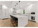 Modern kitchen with white cabinets, marble countertops and island with breakfast bar at 2635 Camp Branch Rd, Buford, GA 30519
