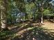 Wooded backyard with a gently sloping lawn at 180 Maddox Rd, Buford, GA 30518