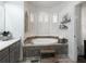 Bathroom with corner soaking tub and tile surround at 180 Maddox Rd, Buford, GA 30518