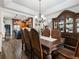 Open dining room with dark wood furniture and kitchen view at 180 Maddox Rd, Buford, GA 30518