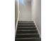 Indoor staircase with carpeted steps and handrail at 4769 Snap Creek Ln, Decatur, GA 30035