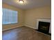 Bright living room with hardwood floors, fireplace, and large window at 5300 Forest Downs Ln, Atlanta, GA 30349