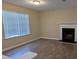 Living room with hardwood floors, fireplace, and window at 5300 Forest Downs Ln, Atlanta, GA 30349