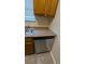 Kitchen features a dishwasher and wood cabinets at 5300 Forest Downs Ln, Atlanta, GA 30349