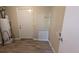 Laundry area with vinyl flooring, water heater, and exterior access at 5300 Forest Downs Ln, Atlanta, GA 30349
