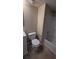 Clean bathroom with tile flooring, a toilet, and a bathtub at 5300 Forest Downs Ln, Atlanta, GA 30349