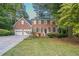 Brick house with two-car garage and landscaped yard at 2097 Kolb Ridge Sw Ct, Marietta, GA 30008