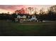 Farmhouse with large yard and driveway, beautiful sunset in the background at 4165 Milford Trl, Cumming, GA 30028