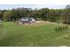 Aerial view of a two-story farmhouse with a large green lawn at 4165 Milford Trl, Cumming, GA 30028