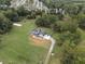 Aerial view showcases the home's setting, including expansive lawn and mature trees at 4165 Milford Trl, Cumming, GA 30028