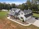 Two story farmhouse with a three-car garage and large backyard at 4165 Milford Trl, Cumming, GA 30028