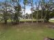 Aerial view of a house with a large backyard, trees, and a woodpile at 4165 Milford Trl, Cumming, GA 30028