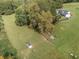 Aerial view of property highlighting outbuildings and surrounding land at 4165 Milford Trl, Cumming, GA 30028