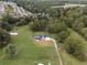 Aerial view of house, expansive lawn, and surrounding trees at 4165 Milford Trl, Cumming, GA 30028