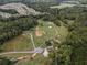 Wide aerial view showing the property, a neighboring community, and surrounding landscape at 4165 Milford Trl, Cumming, GA 30028