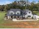 Two story farmhouse with a three-car garage, large yard, and greenhouse at 4165 Milford Trl, Cumming, GA 30028
