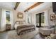 Spacious primary bedroom with hardwood floors, a cozy sitting area, and access to a private patio at 4165 Milford Trl, Cumming, GA 30028