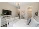 Bright bedroom with white bed, wood flooring, and large windows at 4165 Milford Trl, Cumming, GA 30028