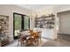 Charming breakfast nook with rustic table, wooden chairs, and access to the backyard at 4165 Milford Trl, Cumming, GA 30028