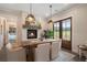 Bright dining area featuring a farmhouse table, fireplace, and French doors leading outside at 4165 Milford Trl, Cumming, GA 30028