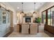 Farmhouse-style dining room with a rustic wooden table, fireplace, and French doors at 4165 Milford Trl, Cumming, GA 30028