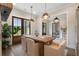 Open dining room showcasing a rustic table, fireplace, and access to the entryway at 4165 Milford Trl, Cumming, GA 30028