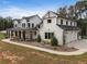 Stunning farmhouse exterior boasts white siding, black accents, and a covered porch at 4165 Milford Trl, Cumming, GA 30028