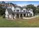 Two story farmhouse with a front porch and large lot at 4165 Milford Trl, Cumming, GA 30028