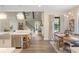 Transitional kitchen with island, breakfast nook, and view to the living room at 4165 Milford Trl, Cumming, GA 30028
