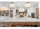 Modern kitchen with marble island, white cabinets, and farmhouse style accents at 4165 Milford Trl, Cumming, GA 30028