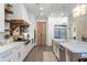 Modern kitchen with white cabinets, marble countertops, and a large island at 4165 Milford Trl, Cumming, GA 30028