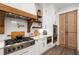 Gourmet kitchen with stainless steel appliances and custom wood accents at 4165 Milford Trl, Cumming, GA 30028