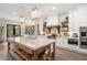 Open kitchen with white cabinets, large island, and stainless steel appliances at 4165 Milford Trl, Cumming, GA 30028