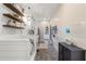 Laundry room with white cabinets, herringbone flooring and dog washing station at 4165 Milford Trl, Cumming, GA 30028