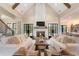 Open living area featuring vaulted ceilings, a stone fireplace, and comfortable seating at 4165 Milford Trl, Cumming, GA 30028