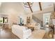 Spacious living area with hardwood floors, exposed beams, and a view into the kitchen at 4165 Milford Trl, Cumming, GA 30028