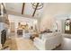 Bright living room with an open floor plan, fireplace, and kitchen views at 4165 Milford Trl, Cumming, GA 30028