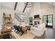 High-ceilinged living room with a cozy fireplace and access to the backyard at 4165 Milford Trl, Cumming, GA 30028