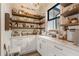 Well-organized pantry with wooden shelves and a variety of food items at 4165 Milford Trl, Cumming, GA 30028