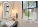 Charming powder room with arched mirror, modern sink and farmhouse style decor at 4165 Milford Trl, Cumming, GA 30028