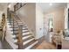 Elegant staircase with wood and metal accents at 4165 Milford Trl, Cumming, GA 30028