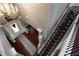 View from above of a grand staircase with dark wood and wrought iron railings at 3770 Falling Leaf Ln, Cumming, GA 30041