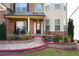 Brick front porch with stonework and lush landscaping at 3770 Falling Leaf Ln, Cumming, GA 30041