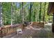 Wooden back deck with grill, overlooking lush green trees at 5051 Heather Se Rd, Smyrna, GA 30082