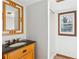Bathroom with a dark countertop, single sink, wooden vanity, and a tiled shower at 5051 Heather Se Rd, Smyrna, GA 30082