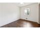 Bright bedroom with dark hardwood floors, white walls, and a large window at 5051 Heather Se Rd, Smyrna, GA 30082
